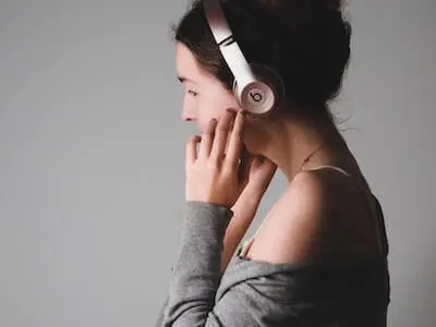 person with dark hair wearing headphones